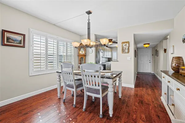 a living room with furniture tv and large windows