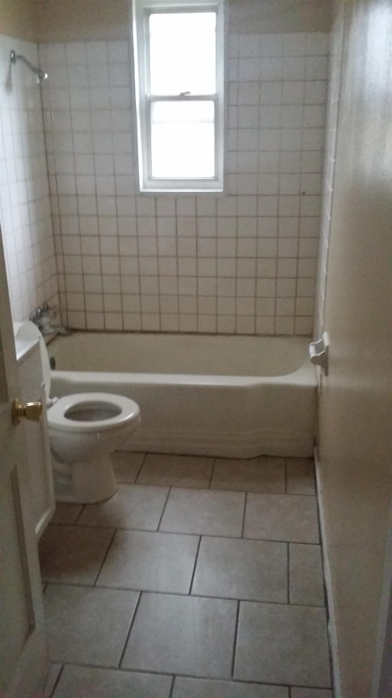 2023 Brighton Road Memphis, TN 38128 - Photo 16 of 21 a bathroom with a toilet a bath tub and a window