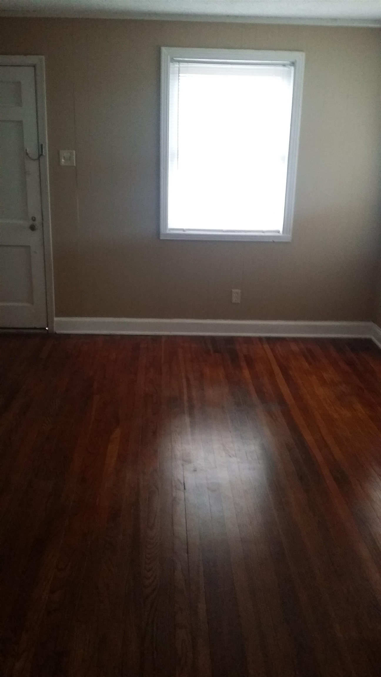2023 Brighton Road Memphis, TN 38128 - Photo 18 of 21 an empty room with wooden floor and windows