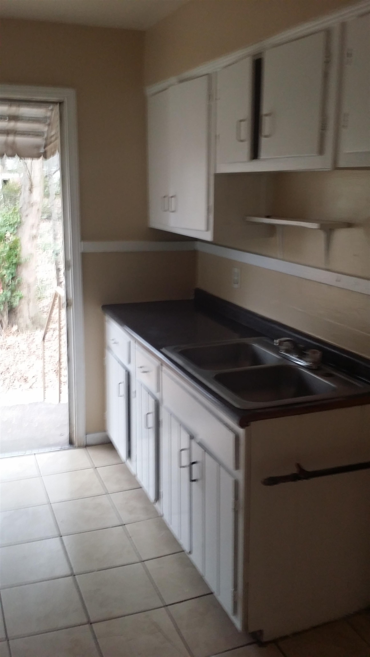 2023 Brighton Road Memphis, TN 38128 - Photo 20 of 21 Kitchen featuring white cabinetry, dark countertops, and light tile patterned floors