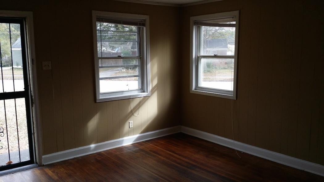 2023 Brighton Road Memphis, TN 38128 - Photo 3 of 21 an empty room with wooden floor and windows