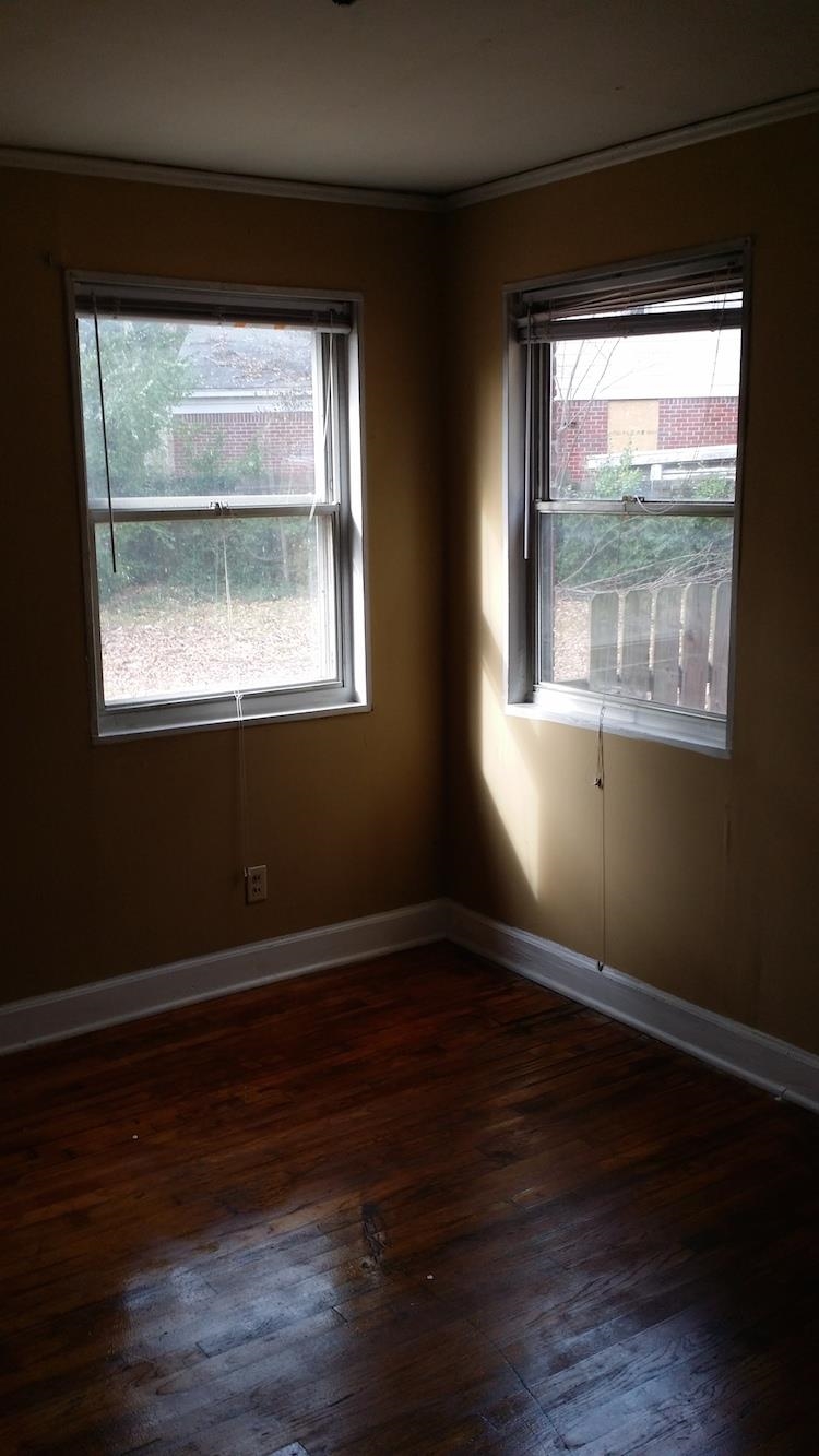 2023 Brighton Road Memphis, TN 38128 - Photo 4 of 21 an empty room with wooden floor and windows