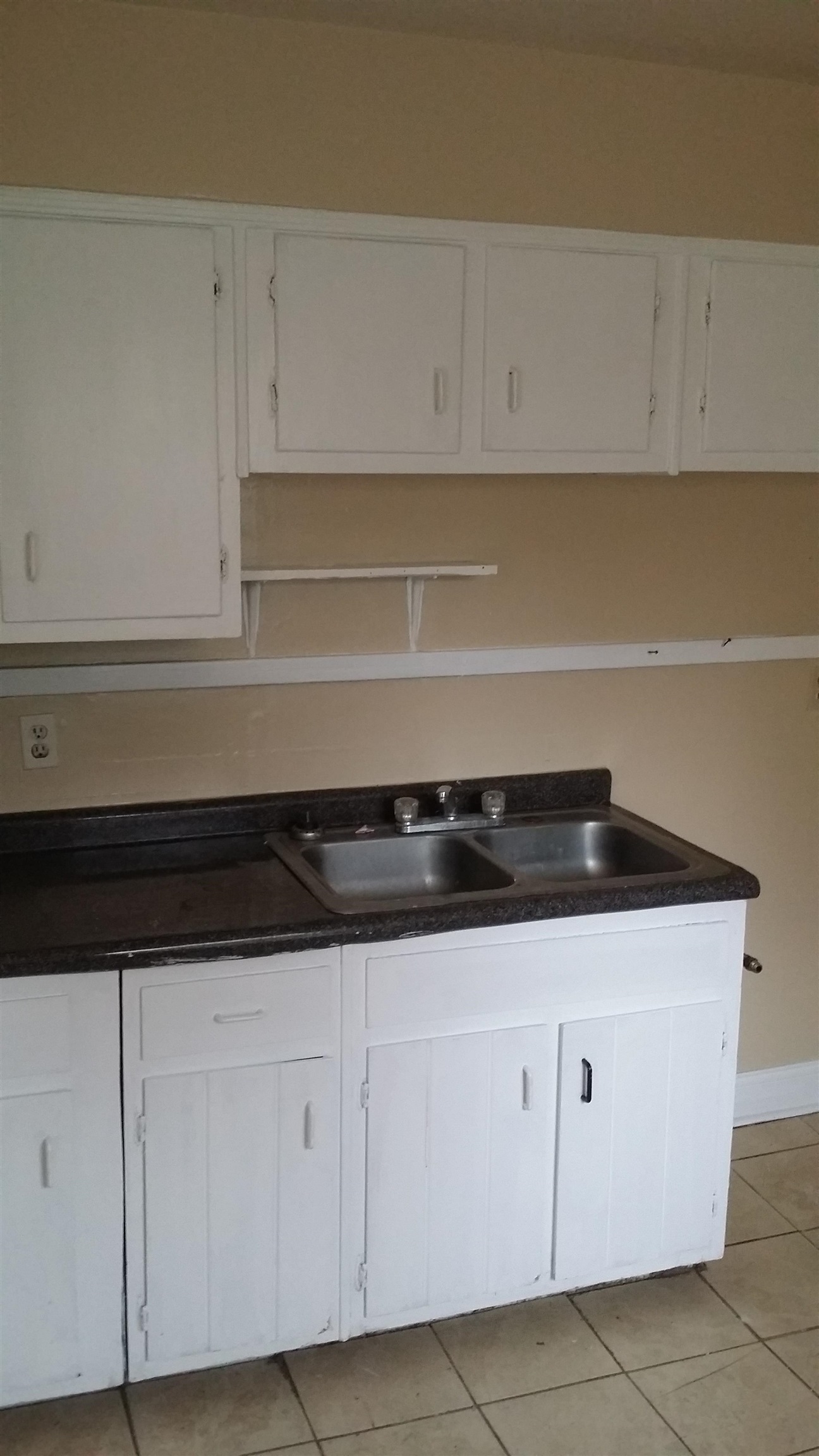 2023 Brighton Road Memphis, TN 38128 - Photo 8 of 21 Kitchen featuring white cabinets, dark countertops, and light tile patterned floors