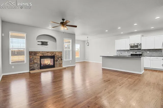 a view of a kitchen with a stove cabinets and wooden floor