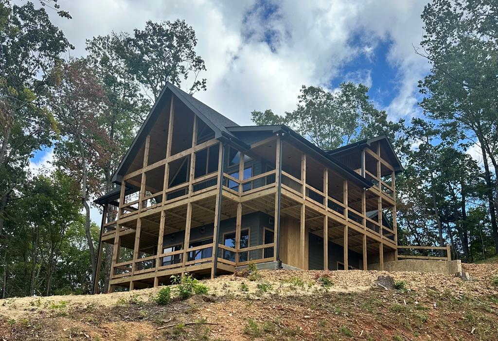 125 Oasis Trail Blue Ridge, GA 30513 - Photo 1 of 1 a front view of a house with a yard and garage