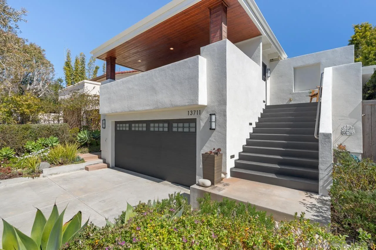 13711 Mercado Drive Del Mar, CA 92014 - Photo 3 of 46 a front view of a house with a garden