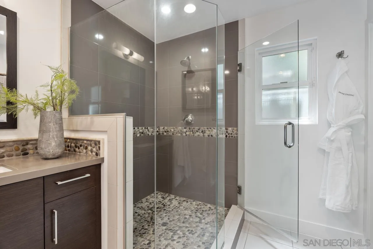 13711 Mercado Drive Del Mar, CA 92014 - Photo 34 of 46 a bathroom with a granite countertop shower a sink and a mirror