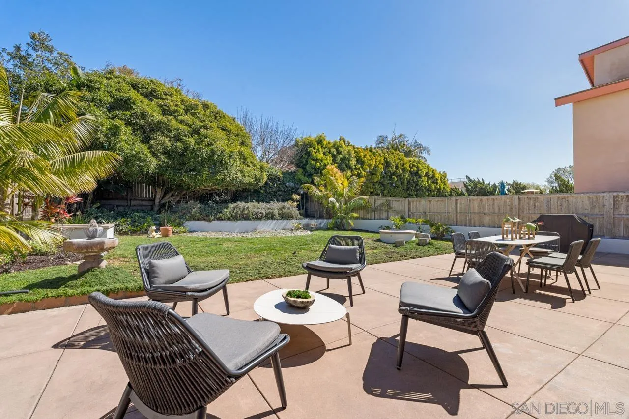 13711 Mercado Drive Del Mar, CA 92014 - Photo 42 of 46 a view of a patio with chairs and table and chairs with wooden fence