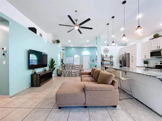 a living room with furniture and a flat screen tv