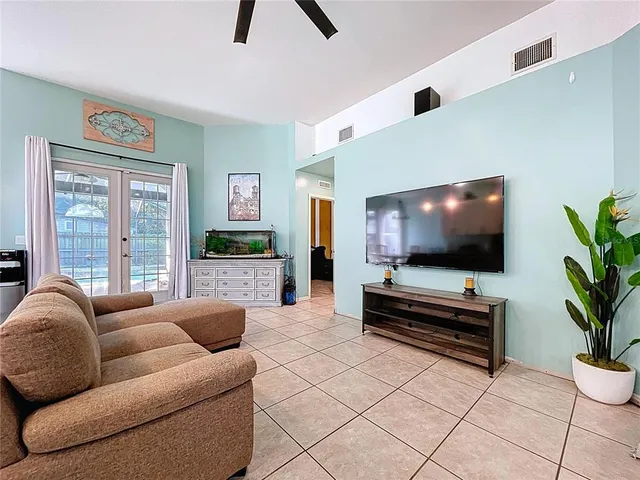 a kitchen with stainless steel appliances granite countertop a sink a stove a refrigerator cabinets and chairs