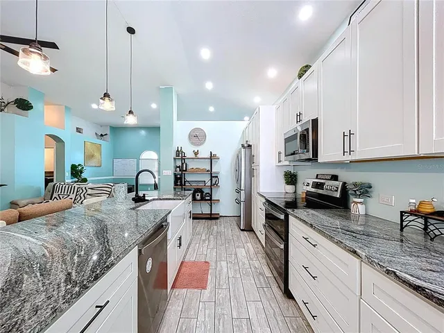 a bed sitting in a spacious bedroom next to a window