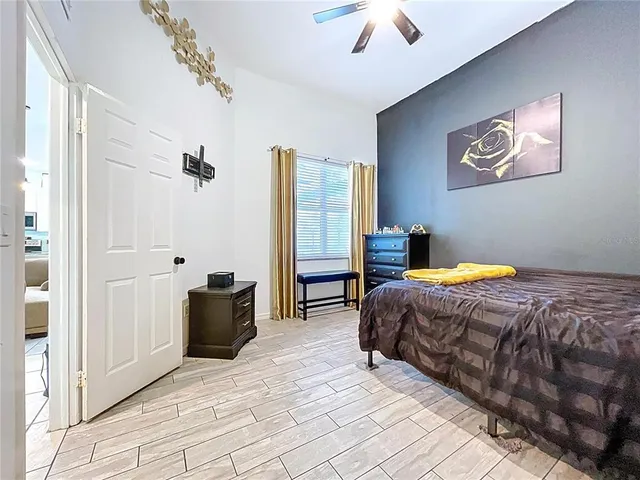 a bedroom with a bed and a mirror