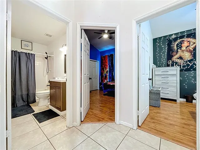 a bathroom with a granite countertop sink a light fixture and a mirror