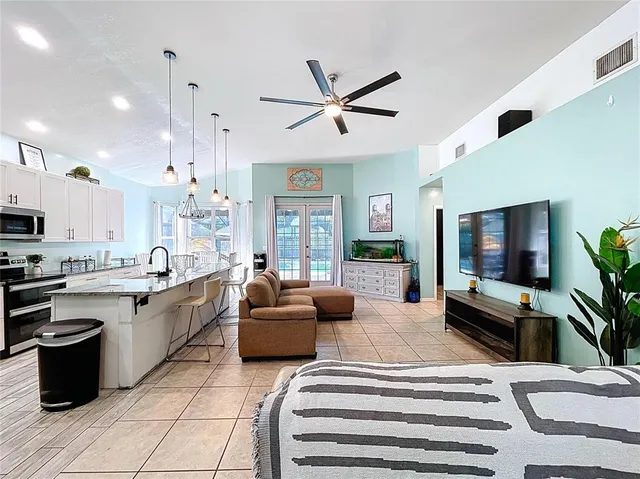a living room with fireplace furniture and a flat screen tv