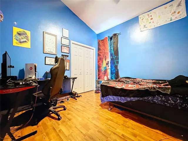 a view of a backyard with table and chairs under an umbrella