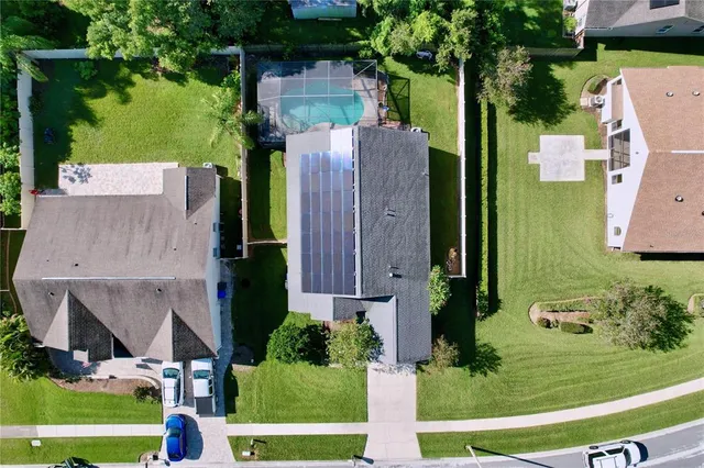 an aerial view of a house with a yard