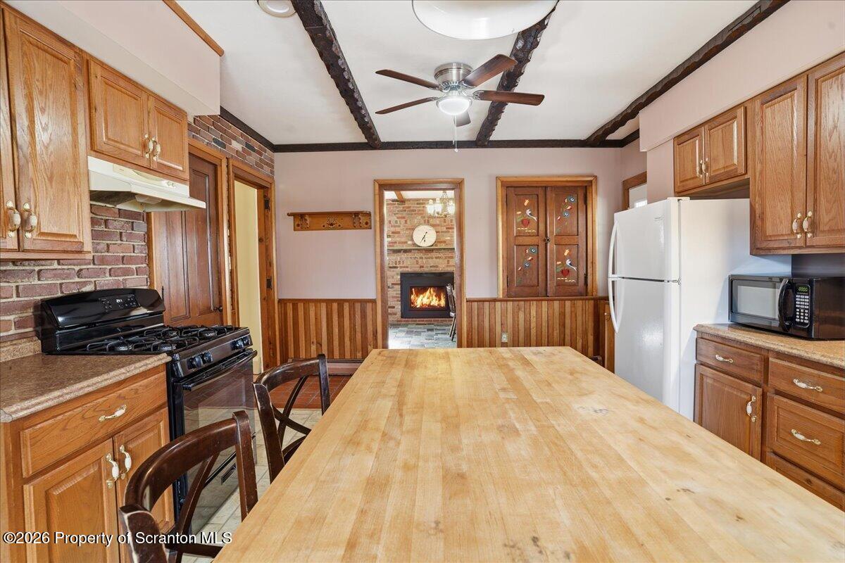 795 Wescott Road New Milford, PA 18834 - Photo 36 of 81 a kitchen with stainless steel appliances granite countertop a refrigerator a stove and a sink with wooden floor