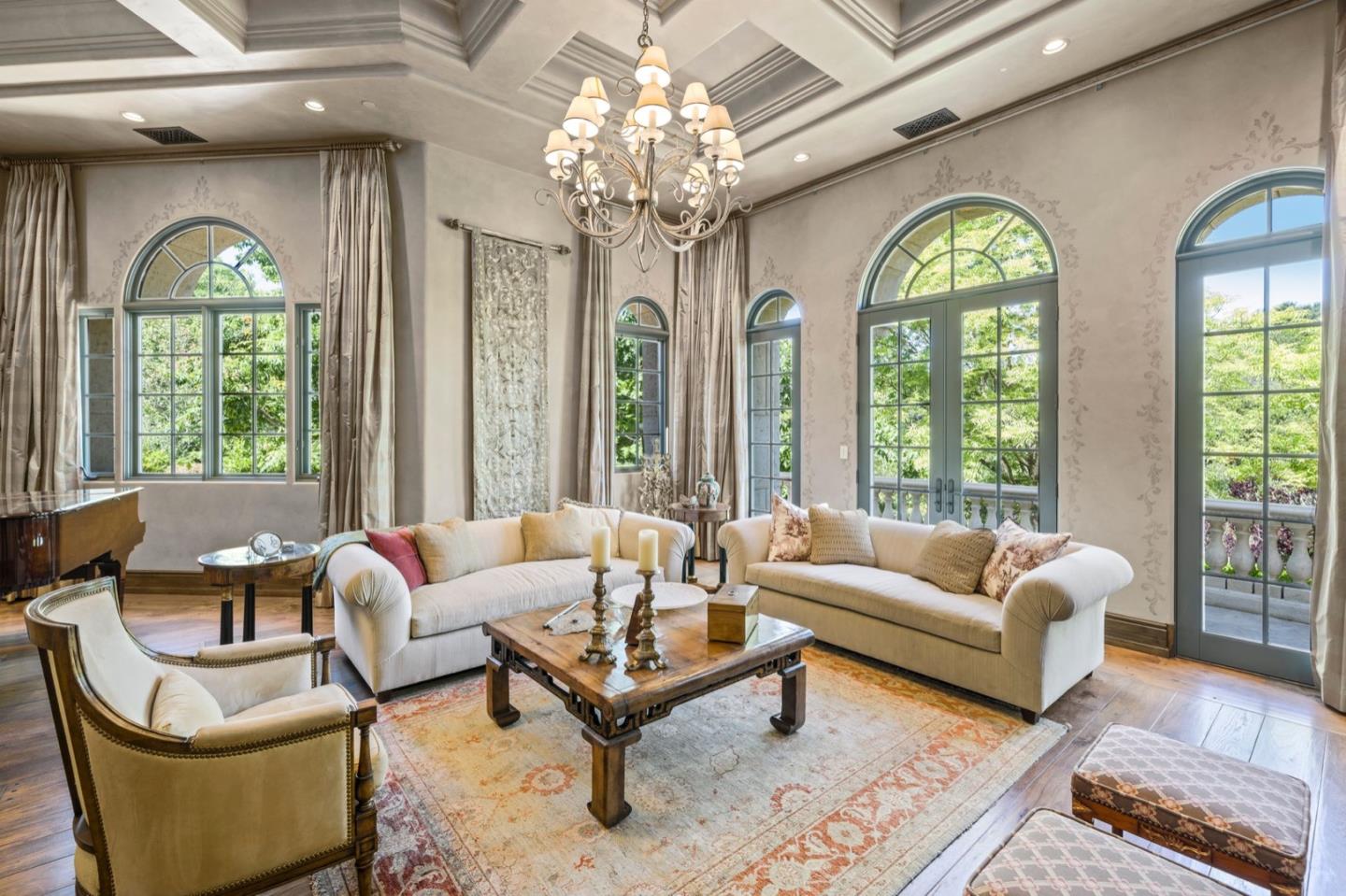 25751 Elena Road Los Altos Hills, CA 94022 - Photo 12 of 80 a living room with couches a table and a chandelier