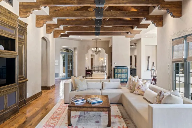 a living room with furniture and a chandelier