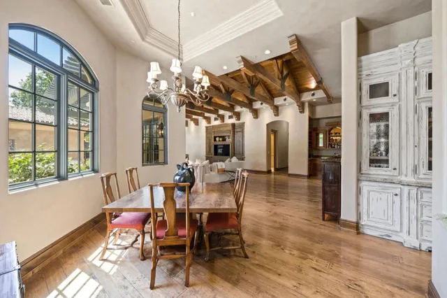 a living room with furniture a chandelier and a flat screen tv