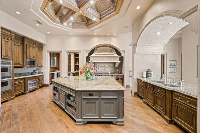 a kitchen with stainless steel appliances kitchen island granite countertop a sink and cabinets