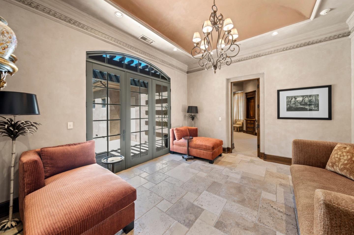 25751 Elena Road Los Altos Hills, CA 94022 - Photo 35 of 80 a living room with furniture a chandelier and a flat screen tv