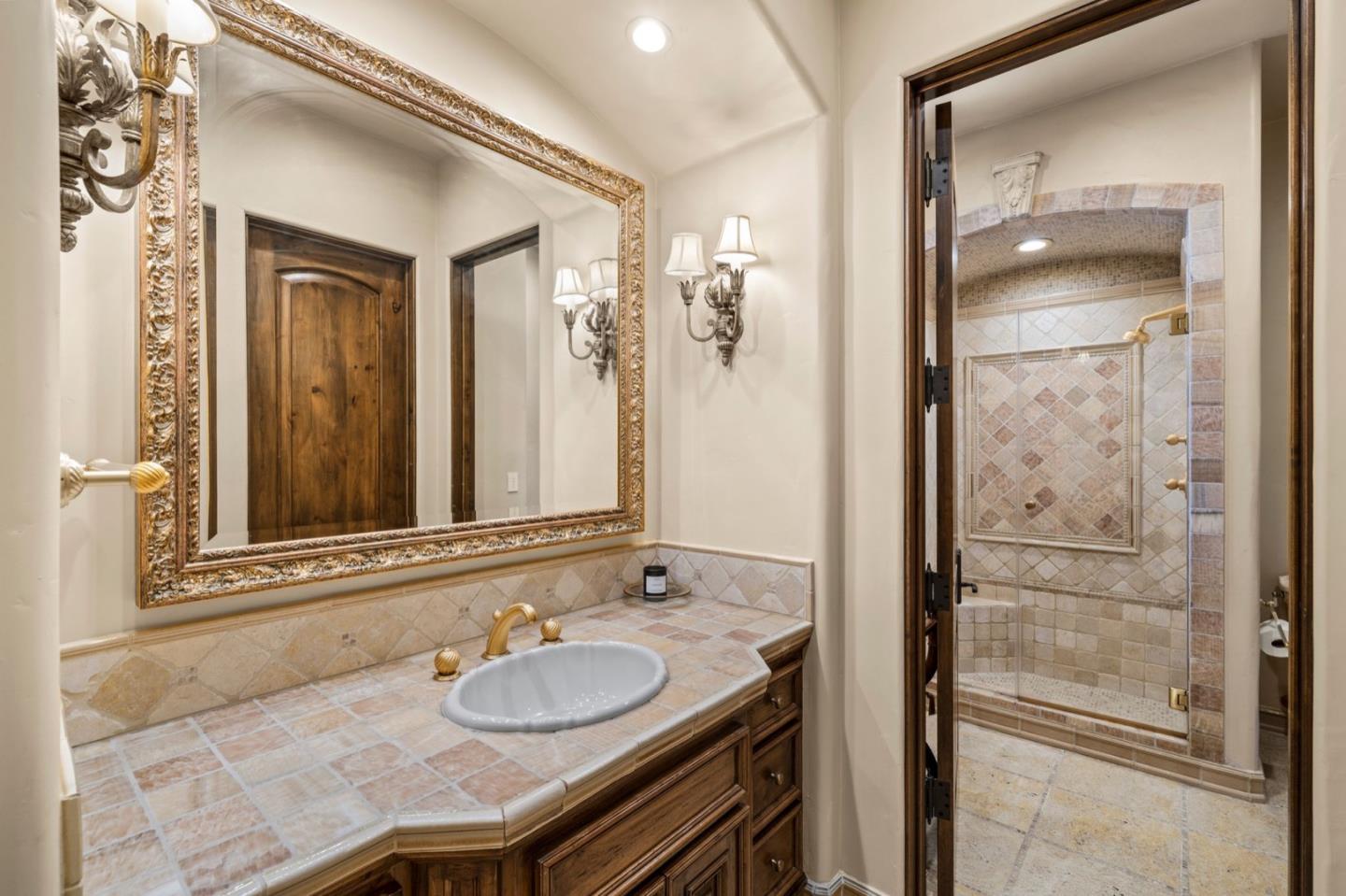25751 Elena Road Los Altos Hills, CA 94022 - Photo 37 of 80 a bathroom with a granite countertop sink and a mirror
