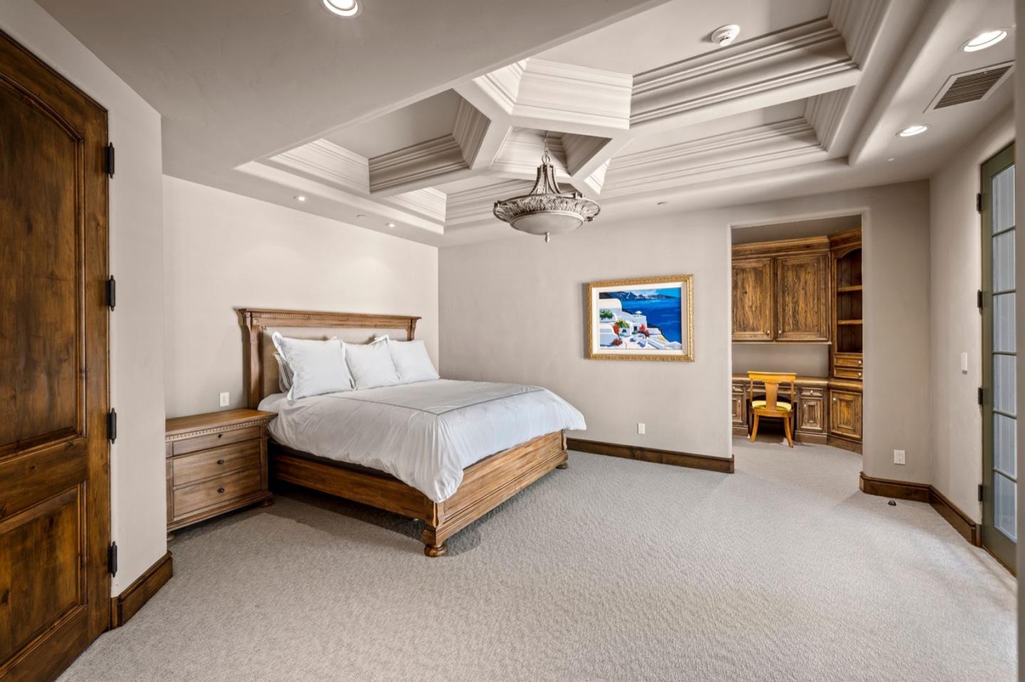 25751 Elena Road Los Altos Hills, CA 94022 - Photo 46 of 80 a bedroom with a bed and a chandelier