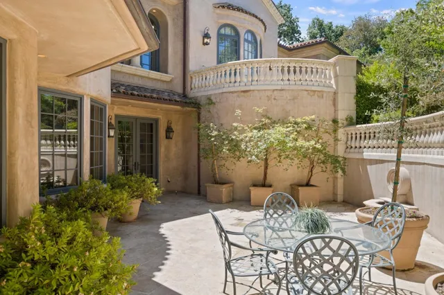 an aerial view of a house with a swimming pool and outdoor space