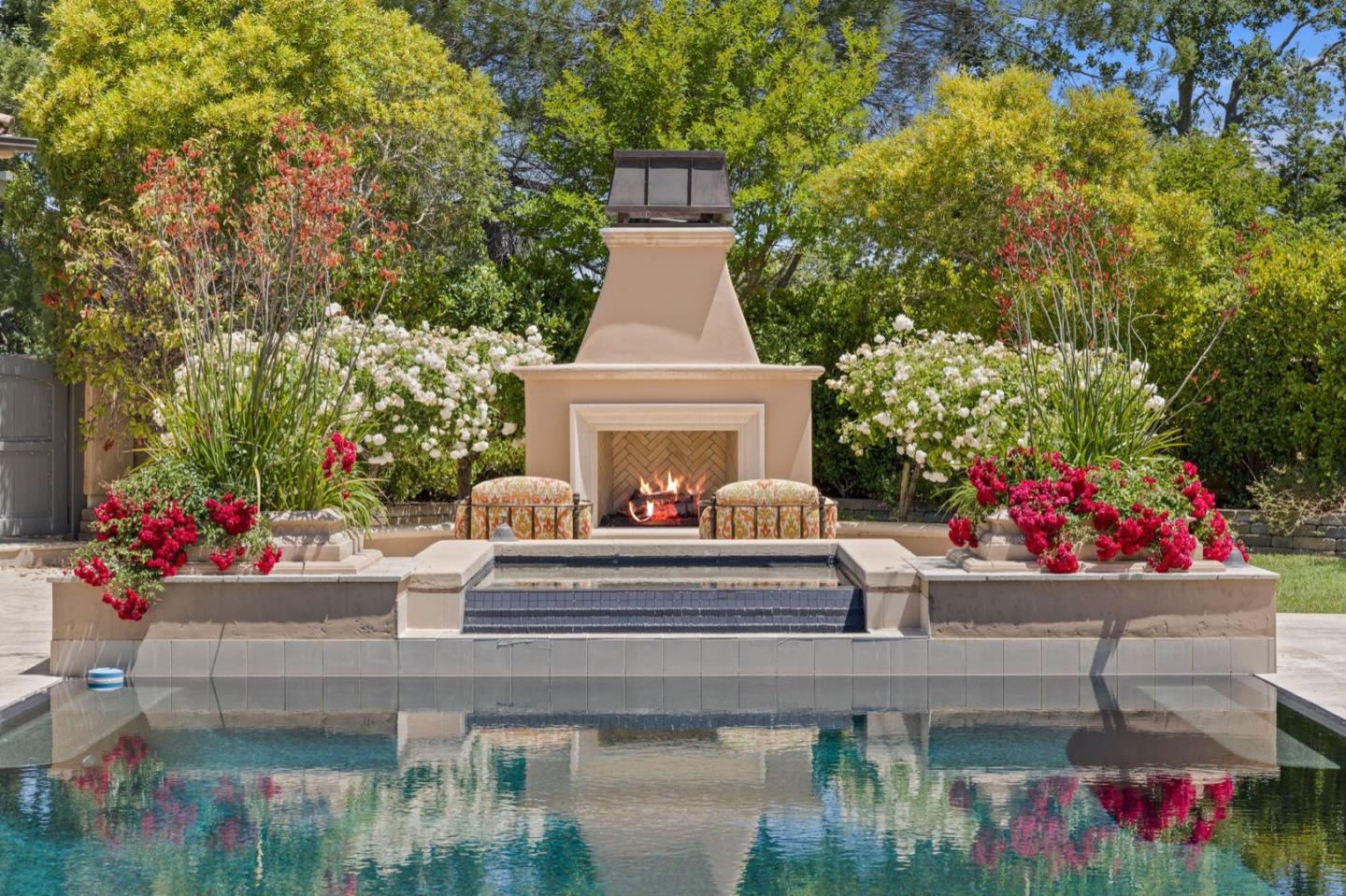 25751 Elena Road Los Altos Hills, CA 94022 - Photo 52 of 80 a view of a dining room with a fireplace and a potted plant