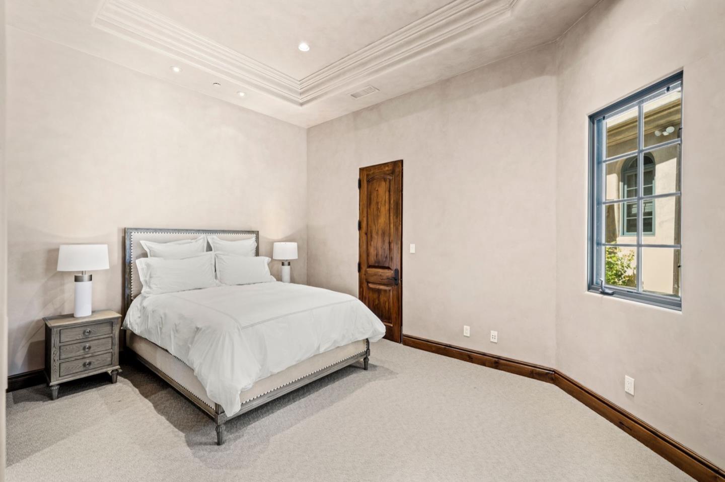 25751 Elena Road Los Altos Hills, CA 94022 - Photo 64 of 80 a bed and a night stand sitting in a bedroom