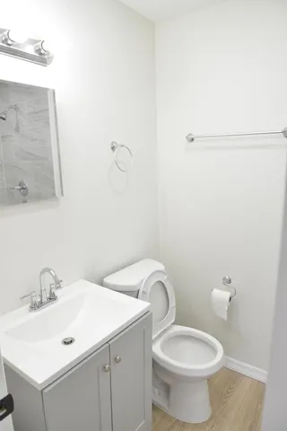 a bathroom with a toilet sink and mirror