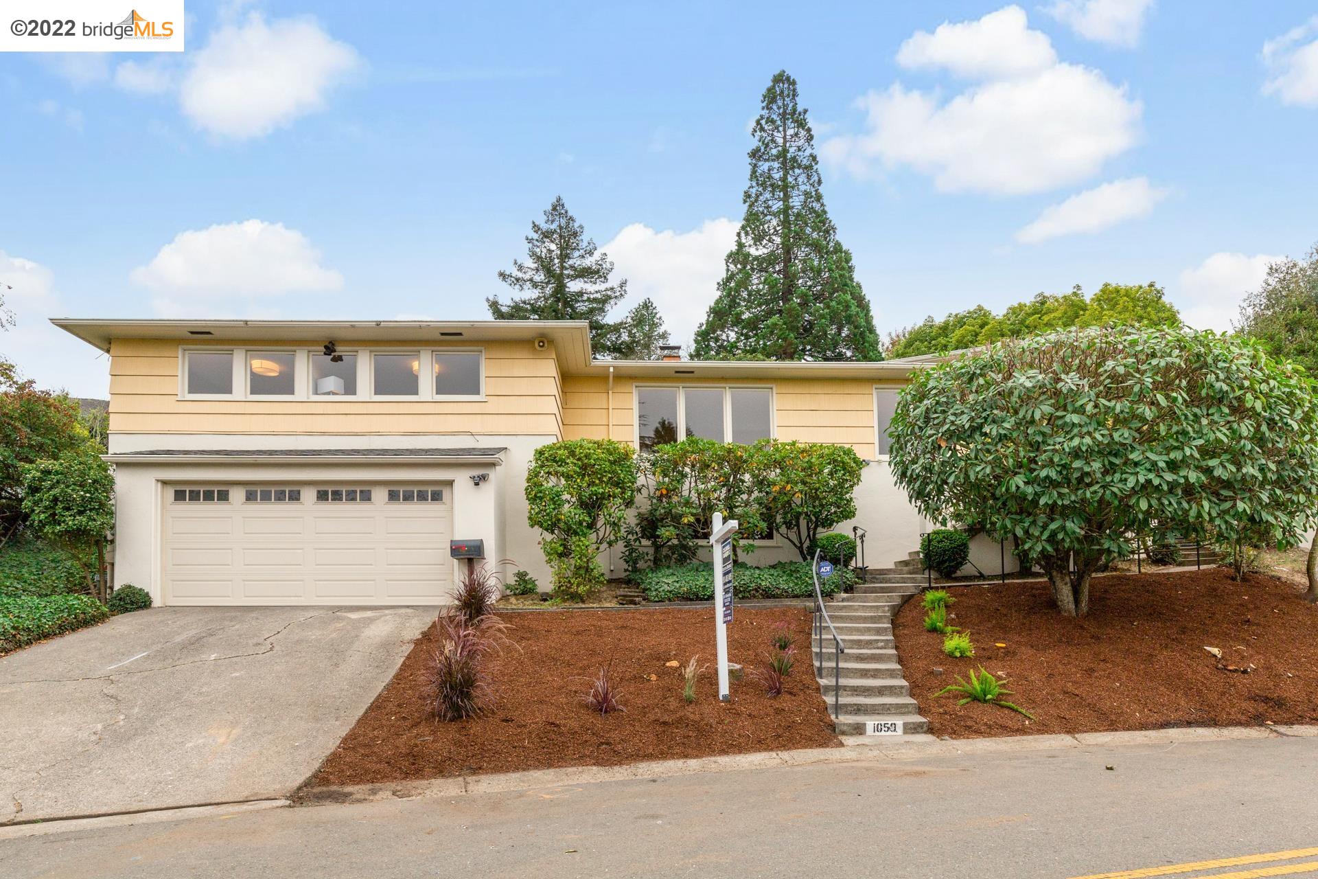 a front view of a house with a yard
