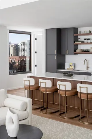 a room with table chairs and kitchen view