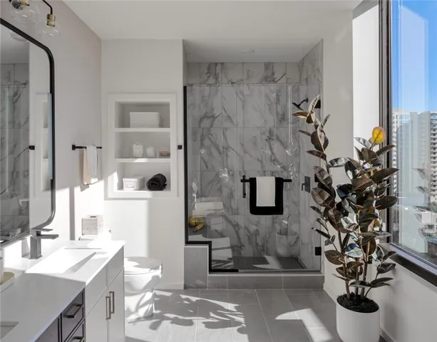 a bathroom with a sink toilet and shower