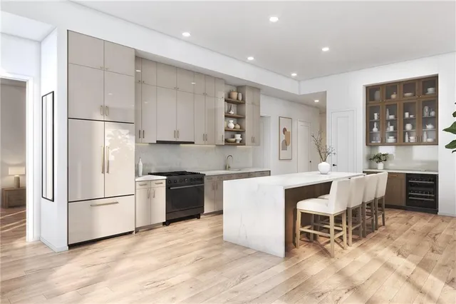 a kitchen with stainless steel appliances kitchen island granite countertop a refrigerator and a stove top oven