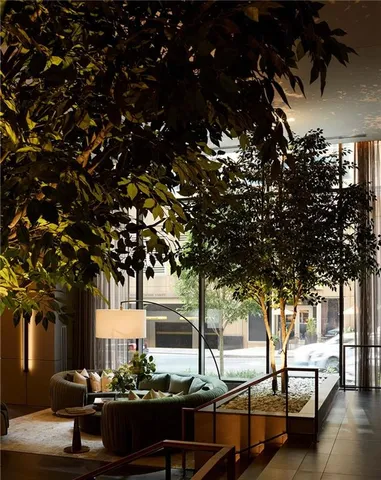 a living room with couches and large trees