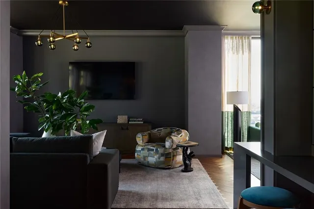 a living room with furniture and a potted plant