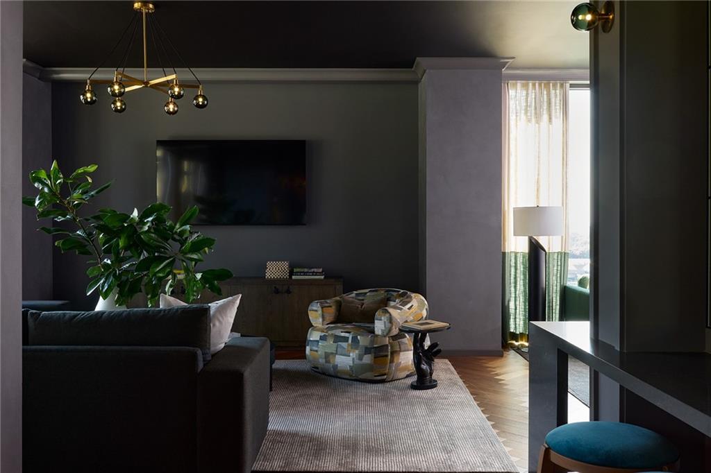 1081 Juniper Street Northeast, Unit S2C Atlanta, GA 30309 - Photo 36 of 46 a living room with furniture and a potted plant