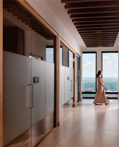 a hallway with sliding door and wooden floor