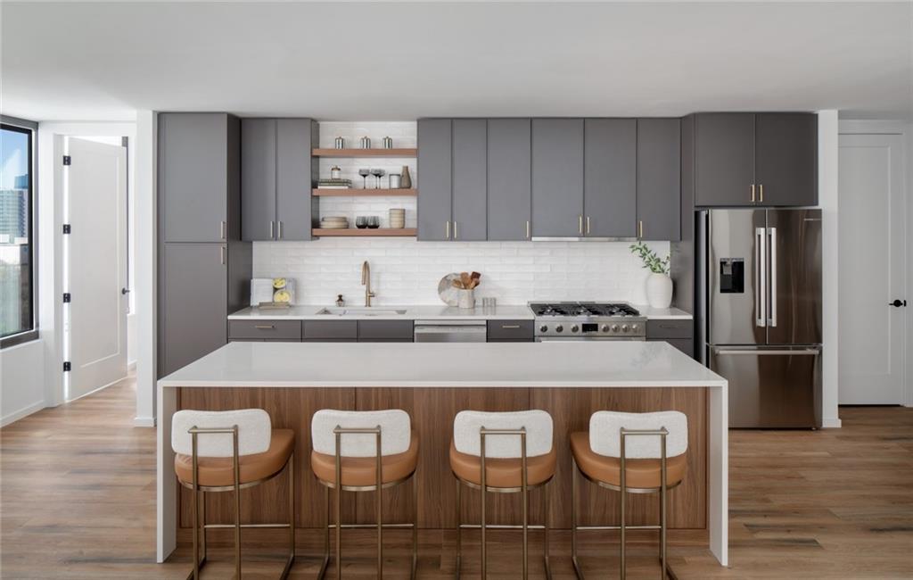 1081 Juniper Street Northeast, Unit S2C Atlanta, GA 30309 - Photo 10 of 46 a kitchen with a dining table chairs and refrigerator