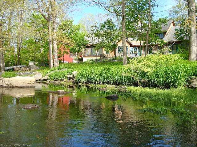 100 Neck Road Madison, CT 06443 - Photo 1 of 1 Waterfront/Dock/Pier. View of the house approaching from the Neck River in a kayak. Beautiful wild lilies fill the river banks, with paths to the house.