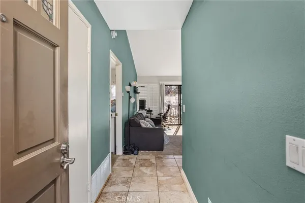 a view of a hallway and a livingroom with furniture