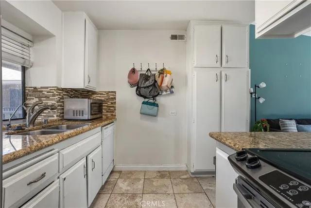 a kitchen with stainless steel appliances granite countertop a stove and a sink