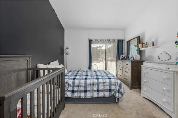 a bedroom with two beds and window
