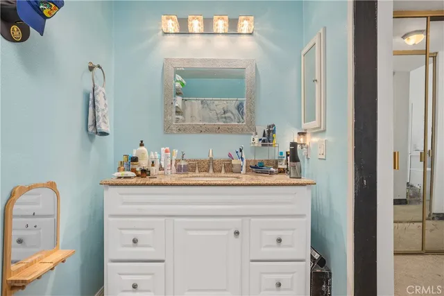 a bathroom with a sink vanity and mirror