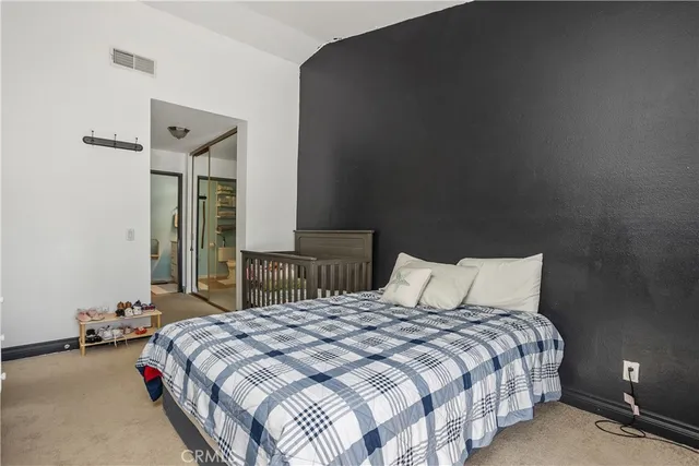 a bedroom with a bed and a night stand