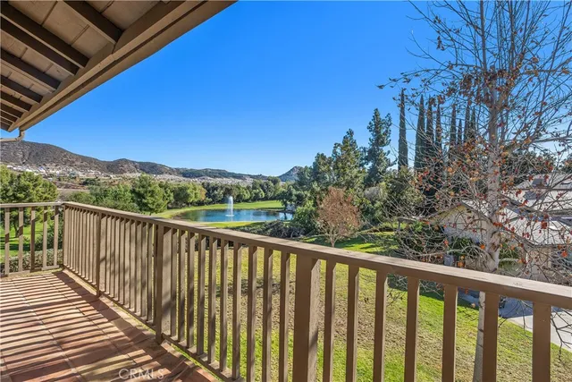 a balcony with wooden floor and city view