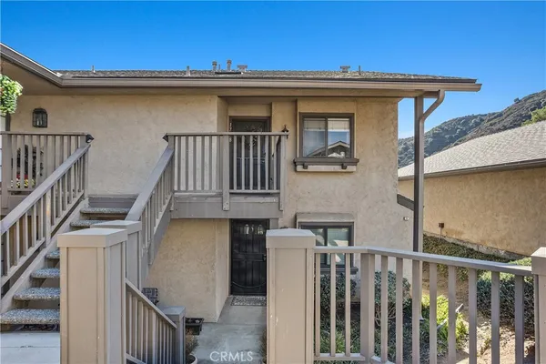 a view of a house with wooden deck
