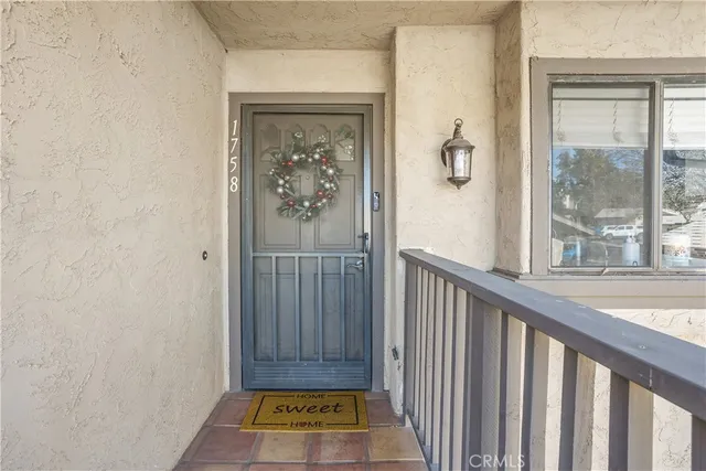 a view of a hallway with wooden floor and a dining room